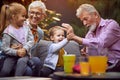 Cheerful grandchildren spending good and funny time with their  grandparents Royalty Free Stock Photo