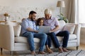 Cheerful grandfather, dad, kid boy using laptop on couch Royalty Free Stock Photo