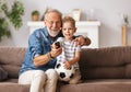 Cheerful grandfather and grandson watching football match Royalty Free Stock Photo