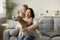 Cheerful grandmother and dog owner woman cuddling beagle Royalty Free Stock Photo