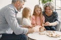 Grandparents play tower game with two girls