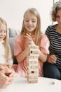 Grandparents play tower game with two girls