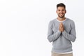 Cheerful and grateful good-looking bearded cute guy in grey sweater appreciate effort, thanking friend for help, hold