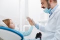 Cheerful great dentist giving his little patient a high five Royalty Free Stock Photo