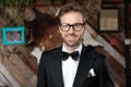 Cheerful groom laughing while wearing glasses