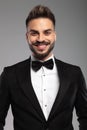 Cheerful groom smiling while wearing tuxedo