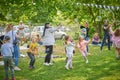 Cheerful group of children joyfully playing together with bubbles in a sunny outdoor park