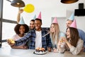 Cheerful group of diverse friends taking selfie while having birthday celebration with yummy cake at home Royalty Free Stock Photo