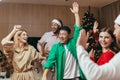 Cheerful Group friends celebrate New Year& x27;s party at home dancing together Christmas eve having fun. house New Year Royalty Free Stock Photo