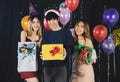 Cheerful group of friends celebrating Christmas and New Year Party holding big box gifts and smiling Royalty Free Stock Photo