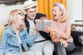 Cheerful group of friends eating popcorn at home Royalty Free Stock Photo