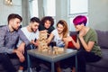 A group of friends play board games in the room.