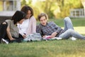 Cheerful group of multiethnic students studying outdoors. Royalty Free Stock Photo