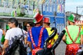 Group of men with clown hats and costumes are walking down the street during a carnival in Salvador