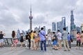 Cheerful group of tourists on Bund Boulevard, Shanghai, China