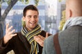 Cheerful guy gesturing to friend Royalty Free Stock Photo