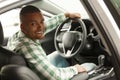 Handsome African man choosing new car at dealership Royalty Free Stock Photo