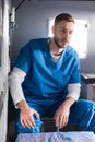 cheerful handsome male doctor sitting Royalty Free Stock Photo