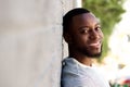 Cheerful handsome man outside leaning against wall Royalty Free Stock Photo