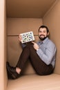 cheerful handsome man pointing at tablet with pinterest website while sitting