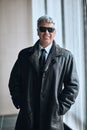 Cheerful handsome man in sunglasses and leather jacket indoors Royalty Free Stock Photo
