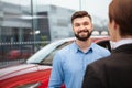 Car dealer selling new autos at the dealership Royalty Free Stock Photo