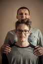 Cheerful handsome teenager boy with father as family portrait Royalty Free Stock Photo