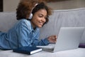 Cheerful happy African student girl enjoying studying at home Royalty Free Stock Photo