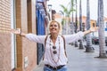 Cheerful happy beautiful caucasian woman enjoy with hands up and opened arms - people and city lifestyle or travel journey trip - Royalty Free Stock Photo