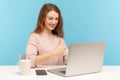 Cheerful happy businesswoman in casual clothes looking at laptop screen and showing thumbs up, talking on video call Royalty Free Stock Photo
