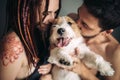 Cheerful and happy couple and the dog, smiling and showing tongu Royalty Free Stock Photo