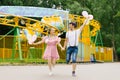 Cheerful happy couple guy and girl holding balloons running and smiling