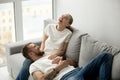 Cheerful happy couple laughing with joy relaxing at home togethe Royalty Free Stock Photo