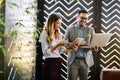 Cheerful coworkers in office working and brainstorming together Royalty Free Stock Photo