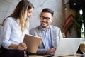 Cheerful coworkers in office working and brainstorming together Royalty Free Stock Photo