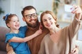 . cheerful happy family mother father and child take selfies, take pictures Royalty Free Stock Photo