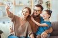 Cheerful happy family mother father and child take selfies, take pictures Royalty Free Stock Photo