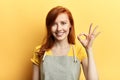 Cheerful happy girl showing ok sign as great sales concept