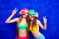 Cheerful happy hipster sisters having fun and holding donutes Royalty Free Stock Photo