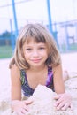 Cheerful happy little girl playing with send at beach enjoying nature - freedom concept. Resting outdoors enjoying sunny