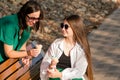 Mom and teenage daughter eat ice cream on walk Royalty Free Stock Photo