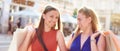 Cheerful happy shopaholic women friends walking on a city street with colorful paper shopping bags - Shoppers buying gifts and