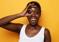 Cheerful happy smiling african american woman looks through zero or ok gesture Royalty Free Stock Photo