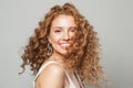 Cheerful happy woman with long natural healthy brown curly hair and cute smile looking at camera on white background. Royalty Free Stock Photo