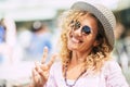 Cheerful and happy young beautiful woman outdoor portrait - middle age mature female with sunglasses and hat smile and enjoy Royalty Free Stock Photo