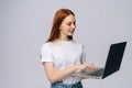 Cheerful happy young business woman or student holding laptop computer and looking away. Royalty Free Stock Photo