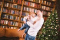 A cheerful and happy young father throws up, holds in his arms and around his neck his little son during a great active Royalty Free Stock Photo