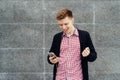 Cheerful happy young man in plaid shirt and jacket Royalty Free Stock Photo