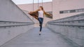 Cheerful and Happy Young Woman Actively Dancing and Jumping While Walking Down a Concrete Urban Pa Royalty Free Stock Photo