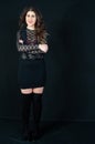 Beautiful close-up of young sensual brunette teen. With black mesh long sleeves in transparent lace, black boots, black mini skirt Royalty Free Stock Photo